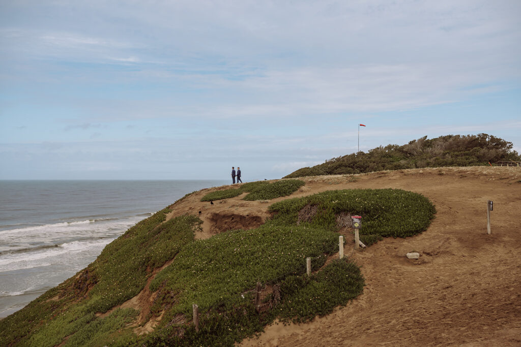 Fort Funston, California was such a breathtaking and intimate wedding and elopement venue for this LGBTQIA+ same sex couple. The cliffside, the beach, and the vast skies made for such beautiful wedding pictures of this adorable couple on their wedding day. The images were captured by Xilo Photography Kati Douglas, Bay Area Intimate Wedding Photographer. She specializes in helping couples intentionally plan and enjoy their intimate and authentic wedding or elopement of their dreams. learn more at xilophotography.com