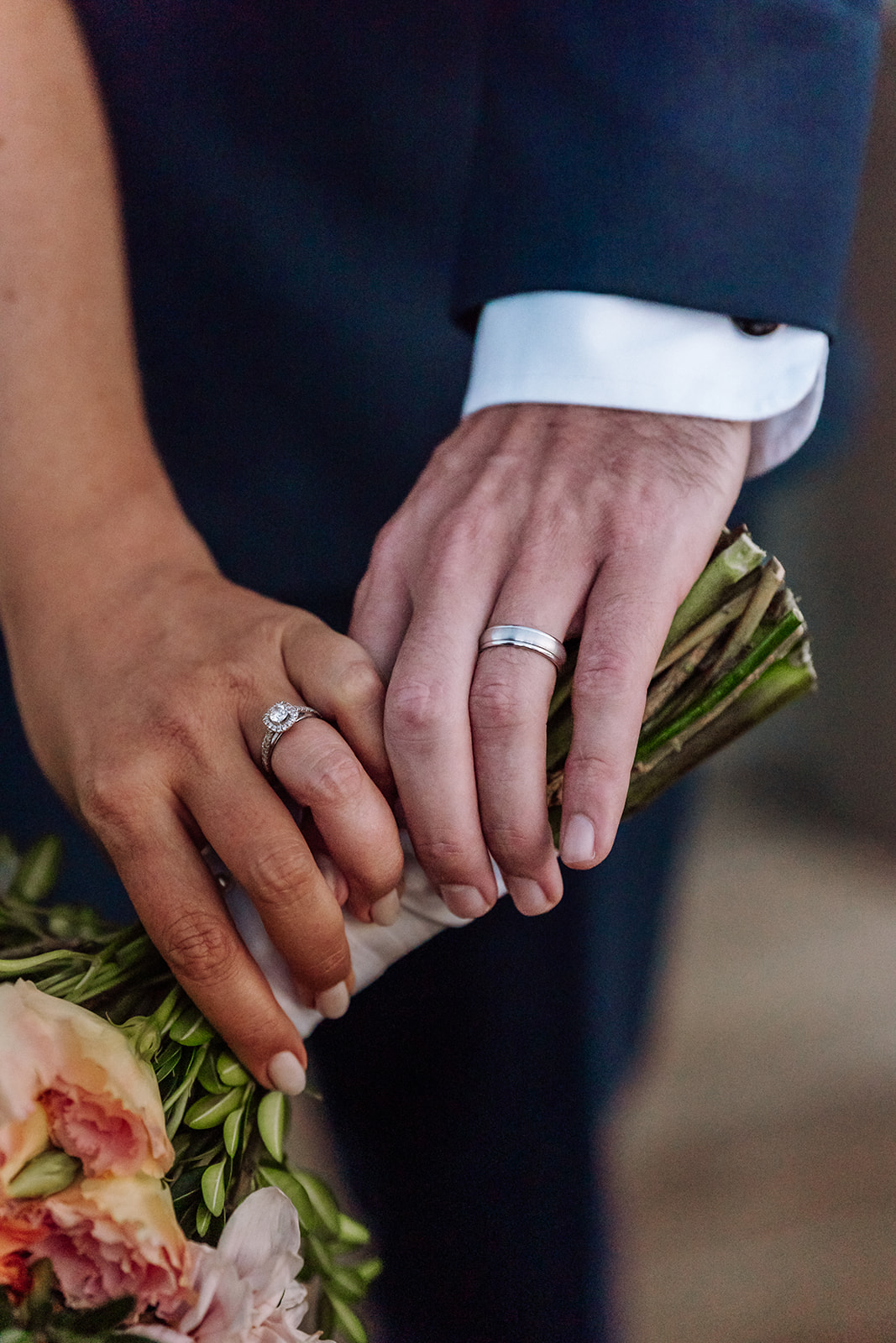 Lake Tahoe, California mountain, forest and beach wedding with the most stunning bouquet being held by the bride and groom, while also showcasing their beautiful wedding and engagement rings. This was considered a fairly intimate and authentic wedding. The views did not disappoint. Photographed by Bay Area photographer, Kati Douglas with Xilo Photography in Oakland, CA